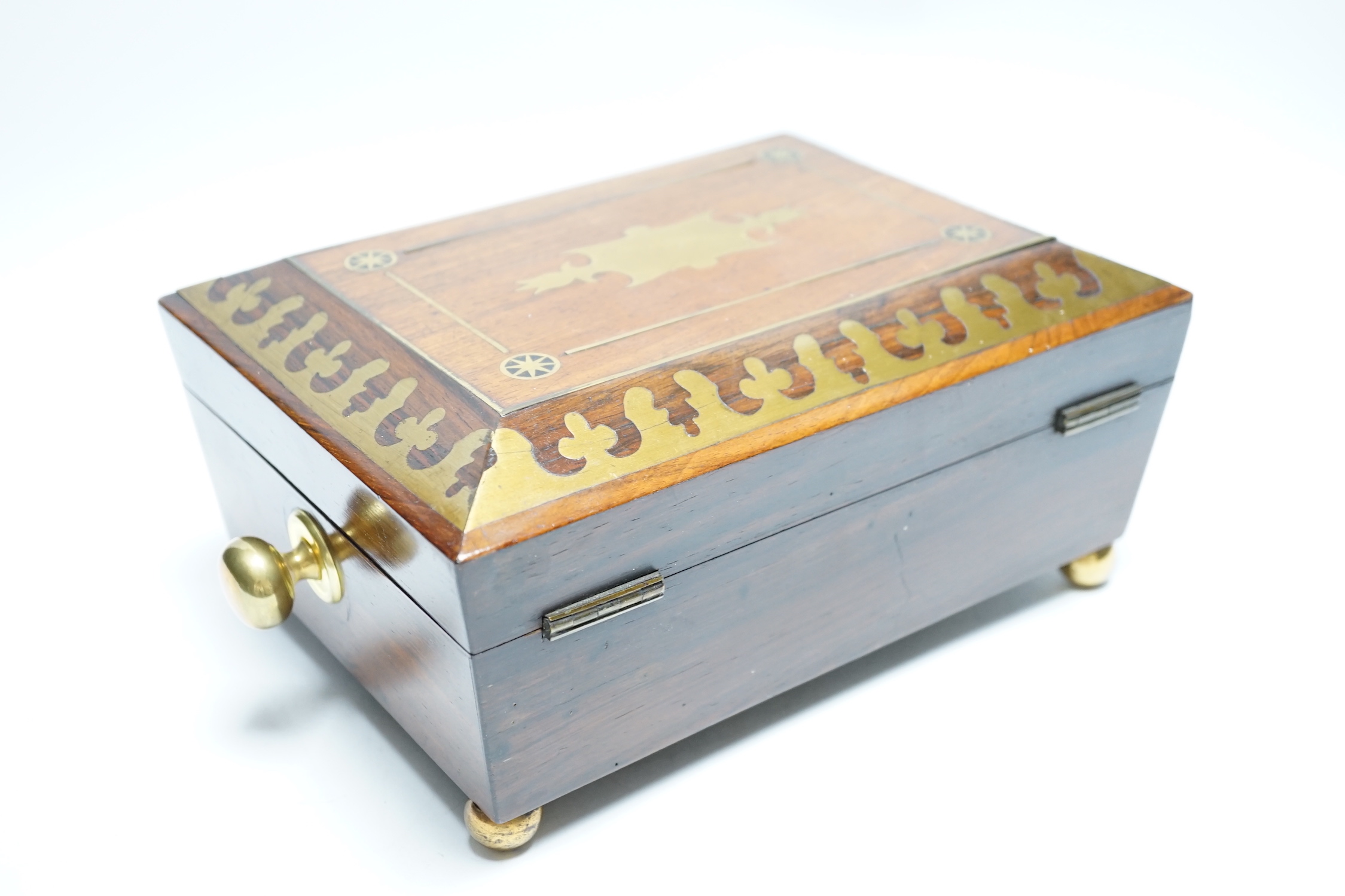 A George IV rosewood and cut brass sewing box with fitted interior, cotton reels, thread and sewing implements, 30cm wide